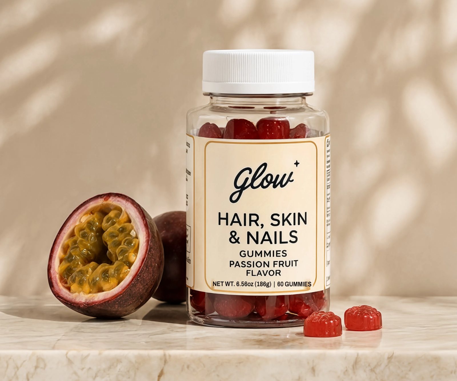 A bottle of Glow Hair, Skin & Nails gummies on marble, beside a halved passion fruit